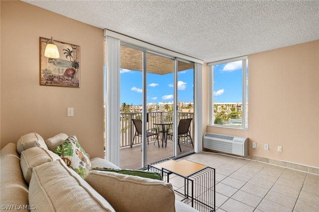 7300 Estero Blvd Unit 301, Fort Myers Beach, FL 33931 - living room featuring light tile patterned floors, an AC wall unit, and a textured ceiling