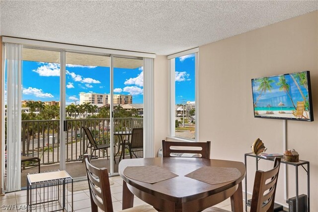 7300 Estero Blvd Unit 301, Fort Myers Beach, FL 33931 - dining room featuring expansive windows, tile patterned flooring, and a textured ceiling