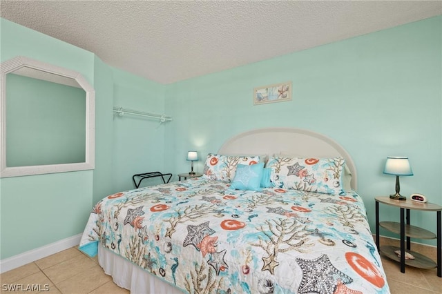 tiled bedroom featuring a textured ceiling