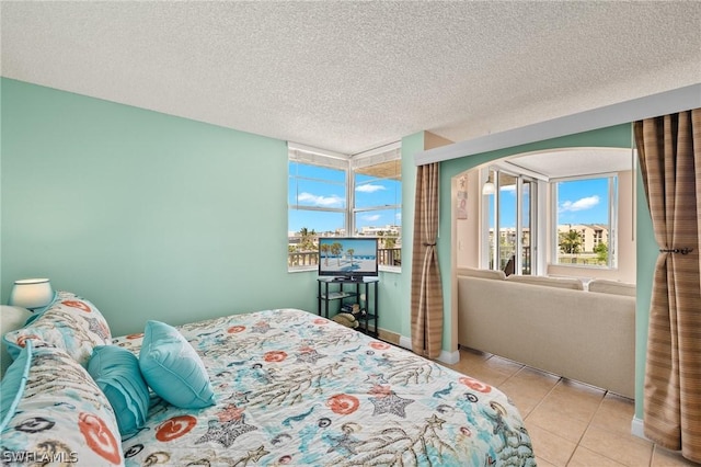7300 Estero Blvd Unit 301, Fort Myers Beach, FL 33931 - bedroom featuring light tile patterned floors and a textured ceiling