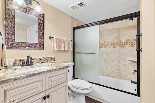 full bathroom with vanity, toilet, and enclosed tub / shower combo