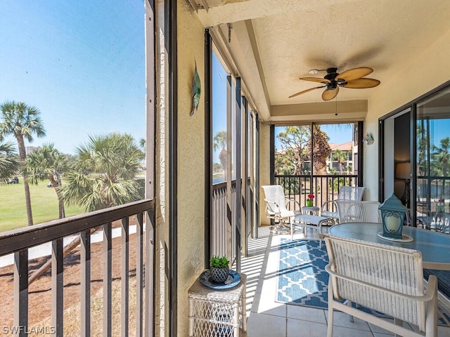 sunroom featuring ceiling fan