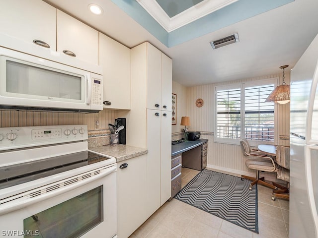 kitchen with white appliances, white cabinetry, hanging light fixtures, and light tile patterned flooring