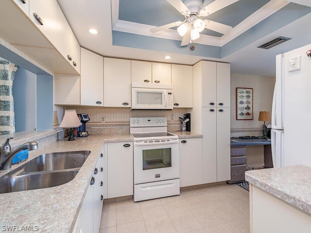 kitchen featuring white cabinets, white appliances, sink, and a tray ceiling