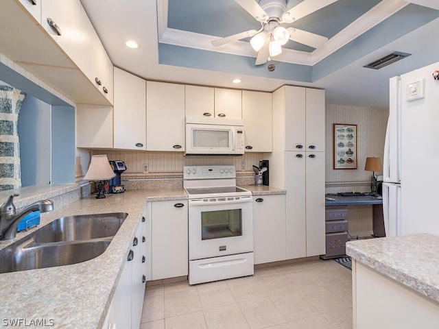 12621 Kelly Sands Way Unit 317, Fort Myers, FL 33908 - kitchen with white appliances, a sink, a raised ceiling, light countertops, and crown molding