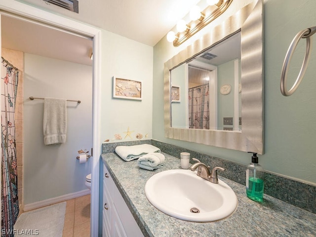 12621 Kelly Sands Way Unit 317, Fort Myers, FL 33908 - full bath featuring vanity, toilet, tile patterned flooring, and a shower with shower curtain