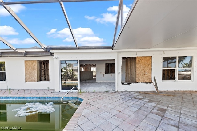 view of pool featuring a patio and glass enclosure