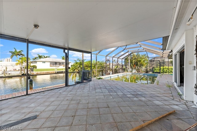 exterior space with a water view and a lanai