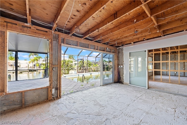 unfurnished sunroom with a water view