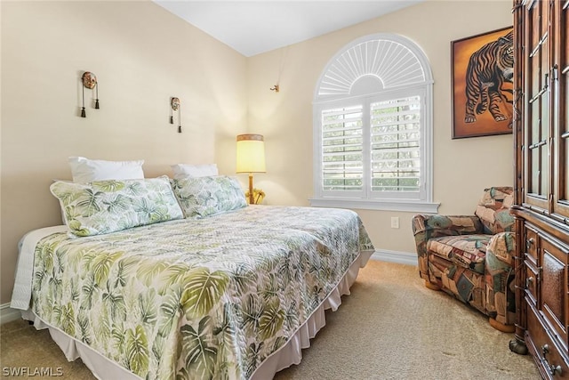 bedroom featuring light carpet