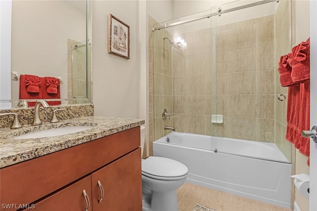 full bathroom with shower / bath combination with glass door, vanity, and toilet