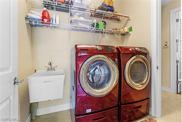 laundry room featuring sink and washer and clothes dryer