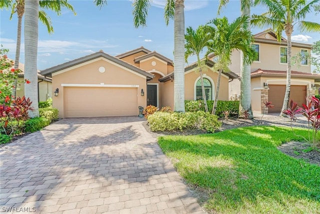 view of front of property featuring a garage and a front lawn