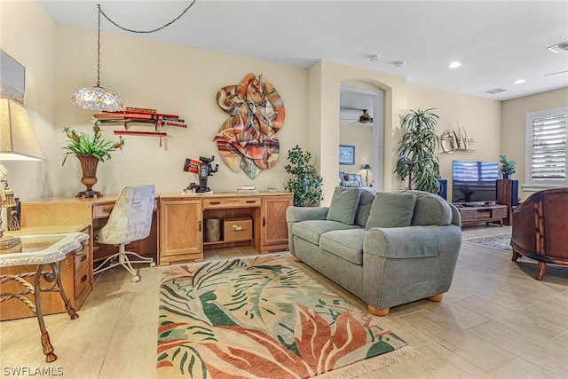 living room featuring ceiling fan and light wood-type flooring