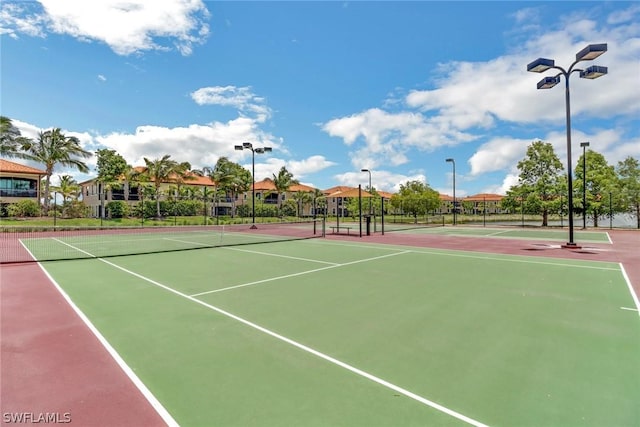 view of tennis court with basketball hoop