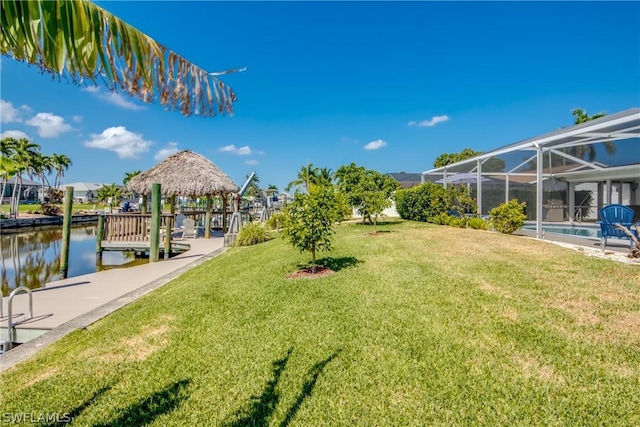 view of yard with a water view and a lanai