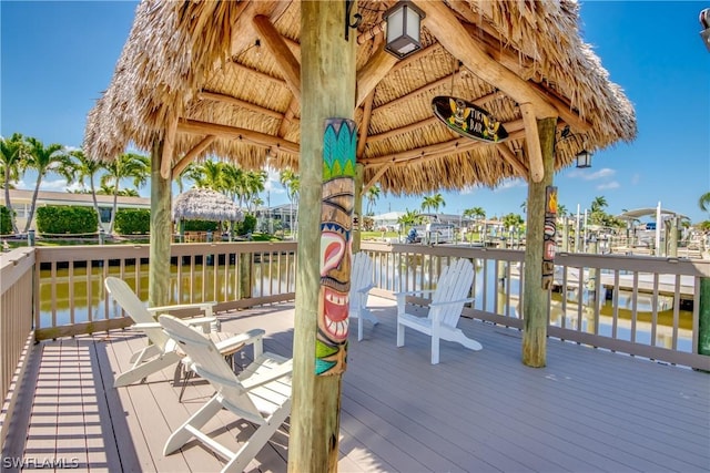 wooden terrace featuring a gazebo and a water view