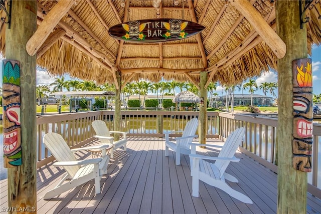 wooden deck with a gazebo and a water view