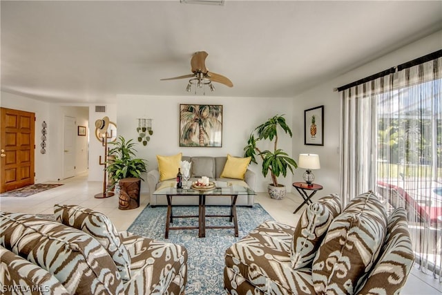 living room with ceiling fan and light tile patterned floors