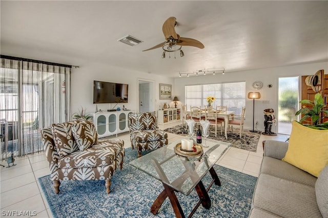 living room with light tile patterned floors and ceiling fan