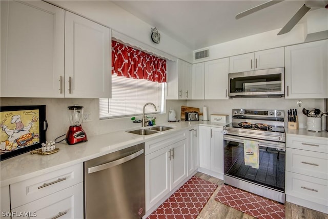 kitchen featuring white cabinetry, sink, ceiling fan, and appliances with stainless steel finishes