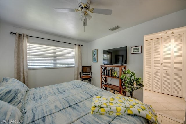 bedroom featuring a closet, ceiling fan, and light tile patterned flooring