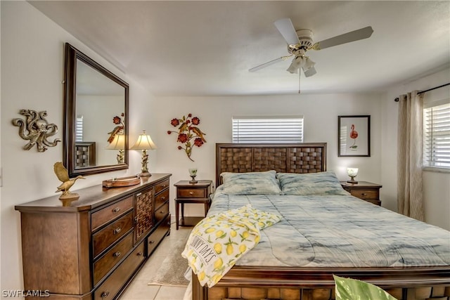 tiled bedroom featuring multiple windows and ceiling fan