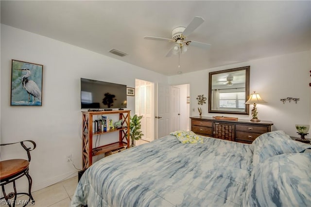 tiled bedroom featuring ceiling fan