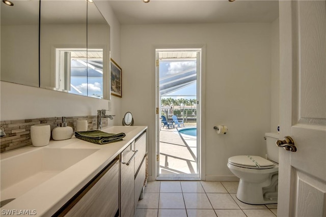 bathroom featuring toilet, vanity, and tile patterned floors