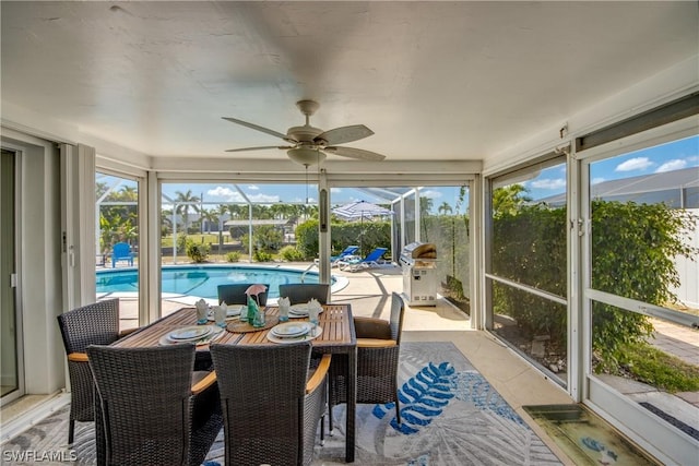 sunroom / solarium featuring ceiling fan and a wealth of natural light