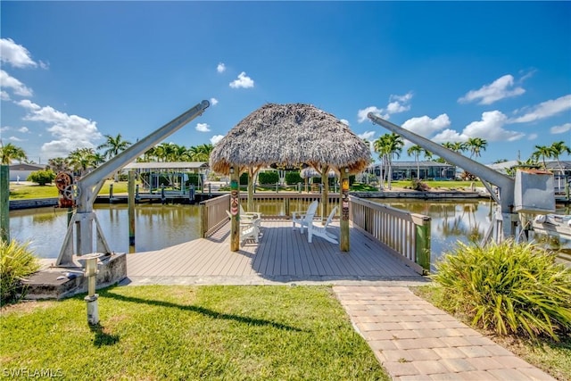 dock area featuring a gazebo, a yard, and a water view