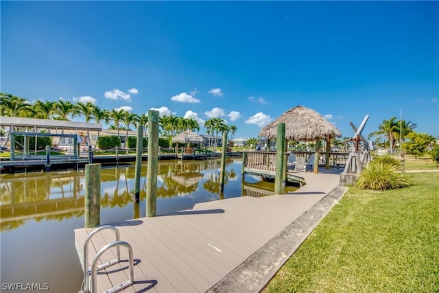 view of dock featuring a gazebo, a yard, and a water view