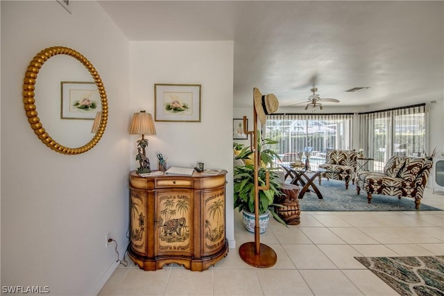 interior space featuring light tile patterned floors and ceiling fan