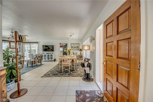 foyer with ceiling fan and light tile patterned flooring