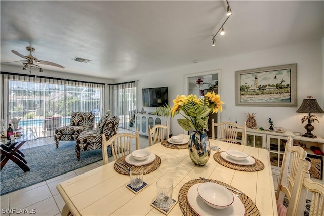 tiled dining area featuring ceiling fan