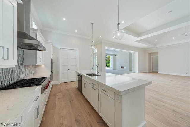 kitchen featuring white cabinets, sink, an island with sink, and stainless steel appliances