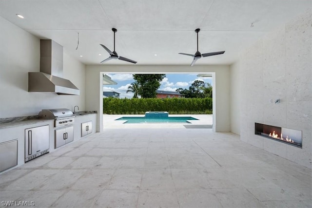 view of patio / terrace featuring a fenced in pool, grilling area, an outdoor kitchen, sink, and a fireplace