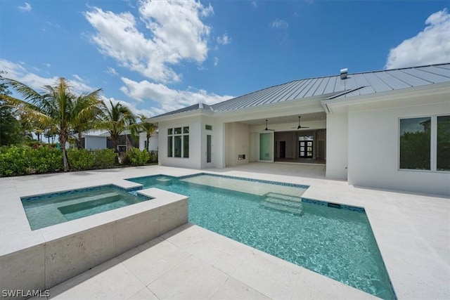 view of pool with ceiling fan, a patio area, and an in ground hot tub