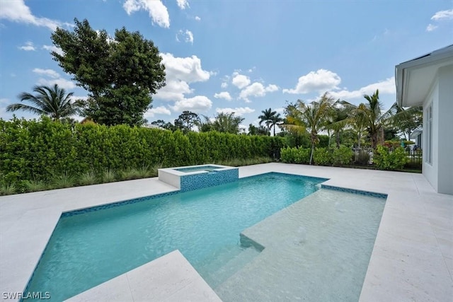 view of swimming pool with an in ground hot tub and a patio