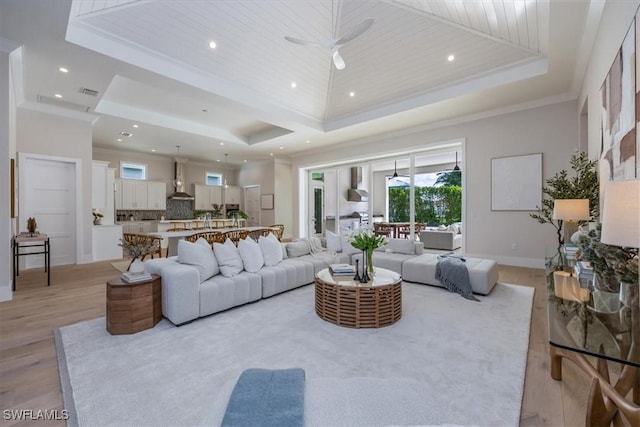 23517 Coconut Landing Dr, Estero, FL 34134 - living area with a tray ceiling, crown molding, light wood-style floors, wood ceiling, and ceiling fan