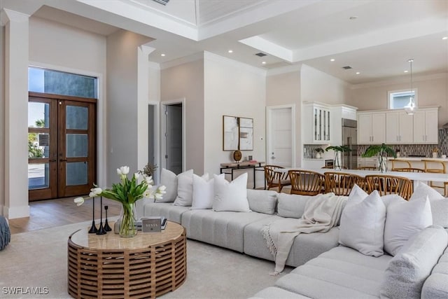 23517 Coconut Landing Dr, Estero, FL 34134 - living room featuring french doors, crown molding, light wood finished floors, recessed lighting, and a towering ceiling