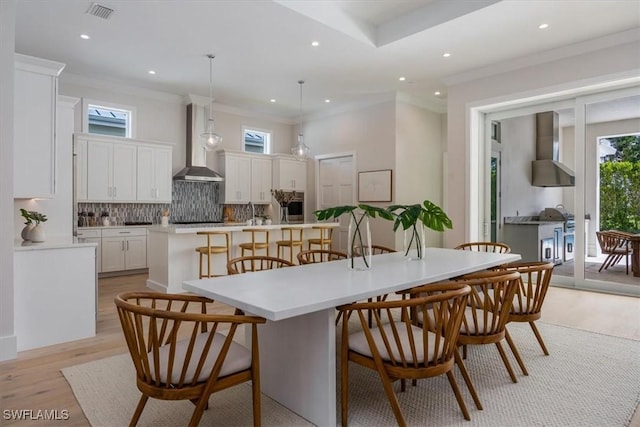 23517 Coconut Landing Dr, Estero, FL 34134 - dining area featuring light wood finished floors, recessed lighting, visible vents, and crown molding