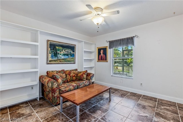 living room with ceiling fan and built in shelves