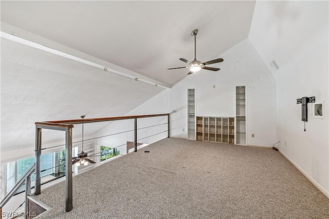 interior space featuring ceiling fan, vaulted ceiling, and carpet floors