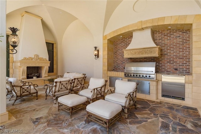 view of patio / terrace featuring a grill, sink, and an outdoor kitchen