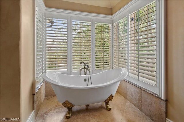 bathroom featuring tile patterned floors, a healthy amount of sunlight, and tiled tub