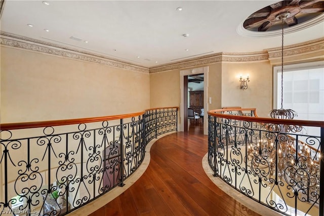 corridor featuring wood-type flooring and ornamental molding