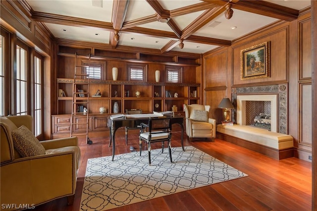 home office with a high end fireplace, coffered ceiling, wooden walls, hardwood / wood-style flooring, and beamed ceiling