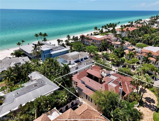 birds eye view of property featuring a water view and a beach view