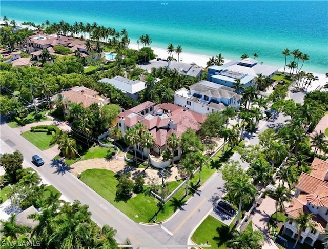 drone / aerial view featuring a water view and a view of the beach